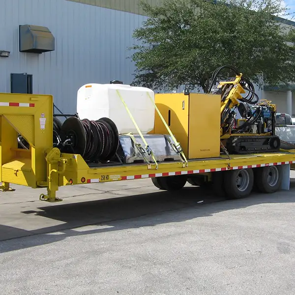 Trailer with hydraulic hose system, drilling pipe, diesel engine and the CGR-174U drill rig.